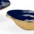 Set of two waving edge bowls in navy with a metallic gold exterior. Small-9.75W x 9.5D x 2.75H 4.3h x 5.5w x 5d