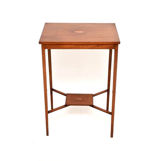 A smart and elegant antique Edwardian inlaid side table. This was made in England, it dates from the 1900-1910 period. It...