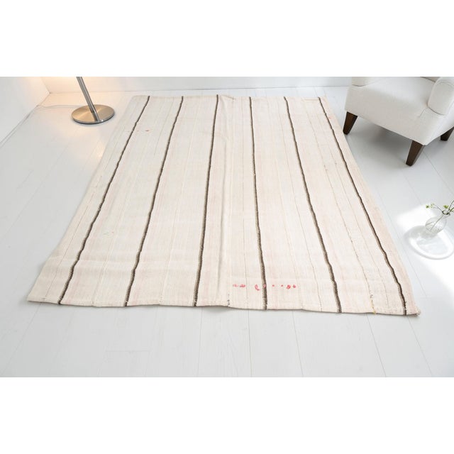 This is a vintage Turkish Oushak rug from the Mid 20th Century. The piece was hand-knotted.