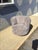 Freshly upholstered swivel lounge chair featuring a sculptural barrel form with softly channel-tufted back panels and a...