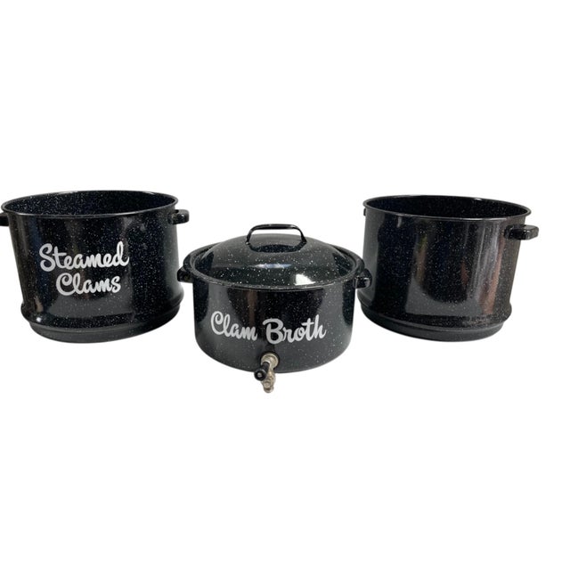 Vintage enamelware steamer pot is designed for cooking clams and collecting their broth. Multi-piece construction with a...