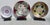 A beautiful assembled set of MCM enamel trays, steel-mounted displays of the brilliant color and play of flashing gold and...