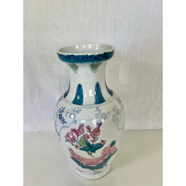 Porcelain vase featuring hand-finished decoration in a soft palette of pink, green, blue and white. The central motif...