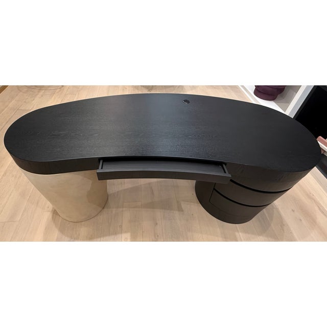 Creative and captivating, it features an expansive wood-veneer top, balanced on rounded legs in an unexpected material...
