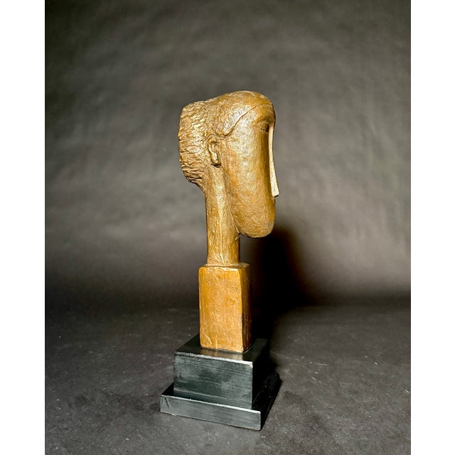 A striking modernist portrait sculpture by Austin Productions, dated 1964, titled Tête de Femme ("Head of a Woman")....