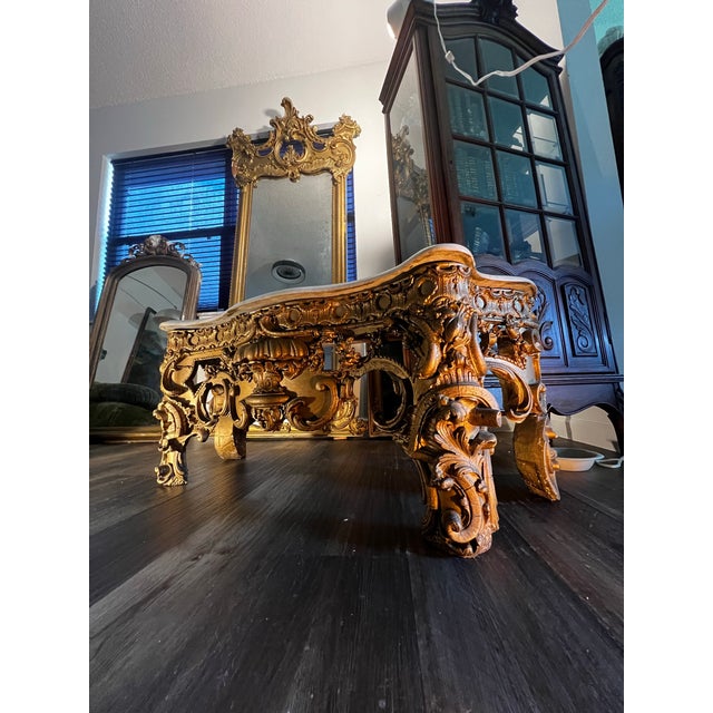 Grand antique French pier mirror with matching console, executed in the Louis XV / Rococo style and featuring richly...