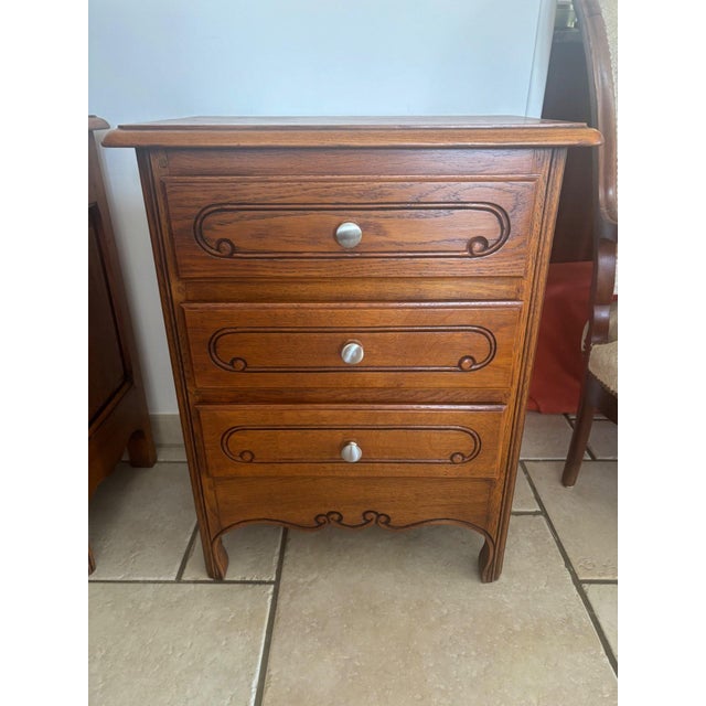 A pair of early 20th-century solid oak bedside tables in the purest louis xv style. each piece features three drawers...