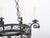 A French iron chandelier from the turn of the century, with six lights and scrollwork motifs. Created in France during the...
