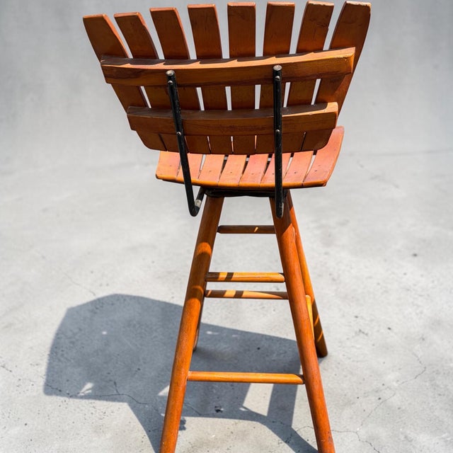 A pair of mcm guitar bar stools. Bring iconic mid-century design into your home with this vintage Arthur Umanoff style...