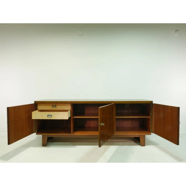 This original vintage sideboard dates back to the 1960s and embodies the functional style of Mid-Century Modern....