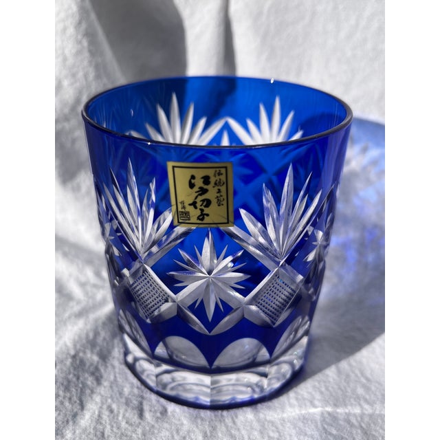 Kaleidoscopic light-catching single blue lowball whiskey glass. Matching red glass listed separately. Edo Kiriko glass was...