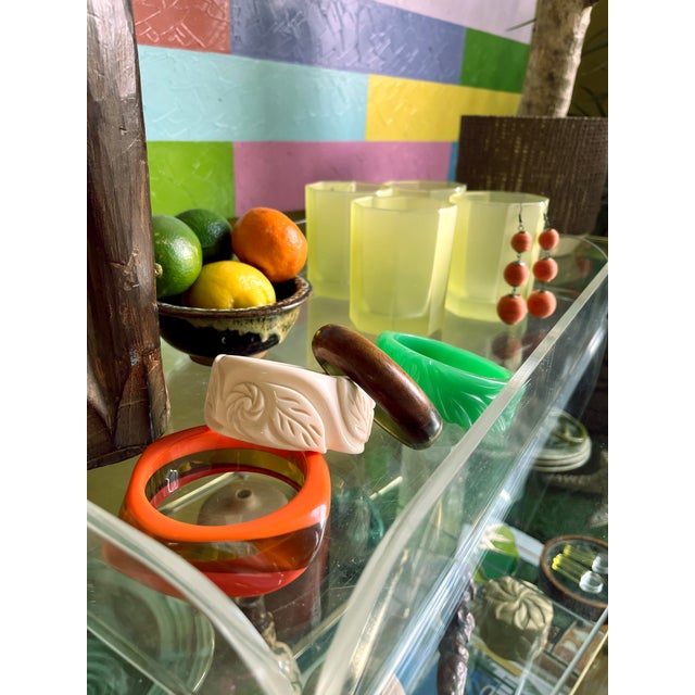 Vintage, Mid-Century ivory-tone plastic bangle in the style of carved Bakelite. Molded floral motif with a rounded profile...