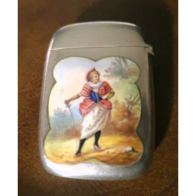 This is a very special and rare match safe. The enamel depicts a lady holding an epee in a lovely landscape. The reverse...