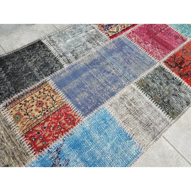 This is a vintage Turkish Oushak rug from the Mid 20th Century. The piece was hand-knotted.