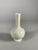 Monochrome white porcelain vase, Dehua kiln, Kangxi dynasty (1661-1722). Wide body resting on a foot and ending in a long...