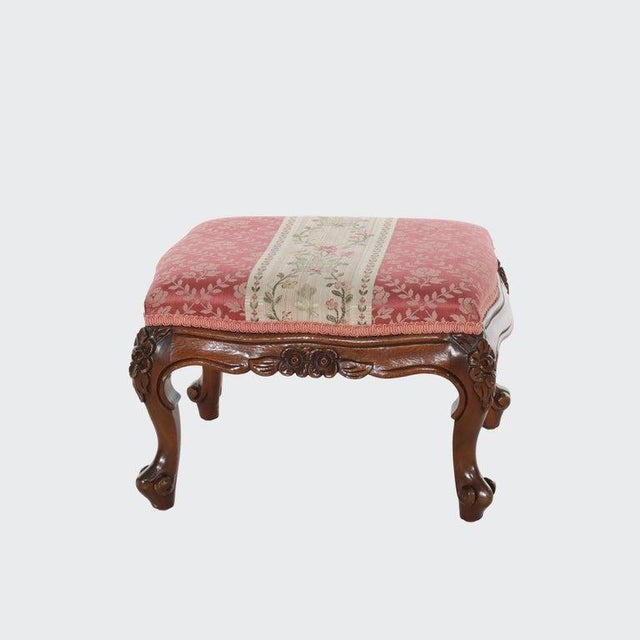An antique Louis XIV style footstool crafted by Colonial Furniture Co., dating to approximately C1880. This finely carved...