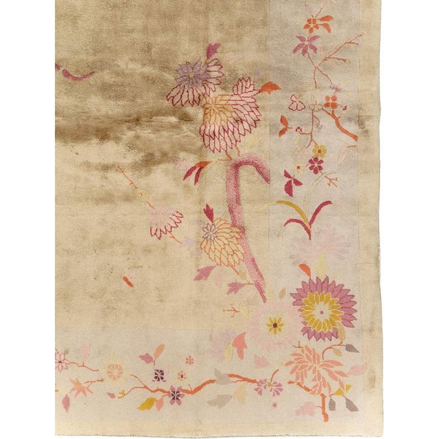 This mid-20th century Chinese Art Deco rug, features an elegant and understated design with delicate floral motifs...