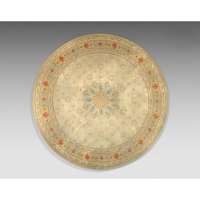 Handwoven in wool, this 12x12 antique Aubusson circle rug is a refined example of late 19th-century French tapestry...