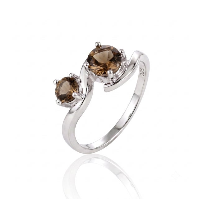This modern ring showcases a dramatic wave-like band that cradles two warm, earthy gemstones, creating an intriguing play...