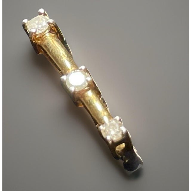 This three-stone diamond bar pendant was crafted in the late 20th century by Charles Masserman. The pendant features three...