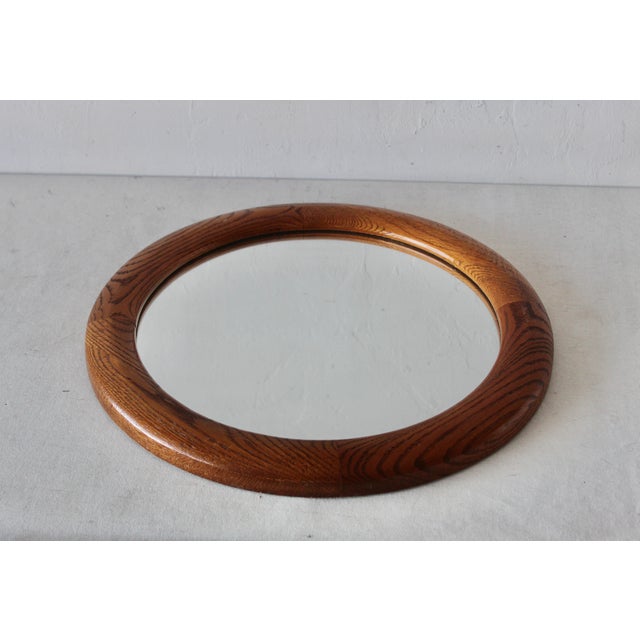 Modern vintage round wall mirror from natural oak and mirror glass. The wall mirror features a beautiful warm vivid color...