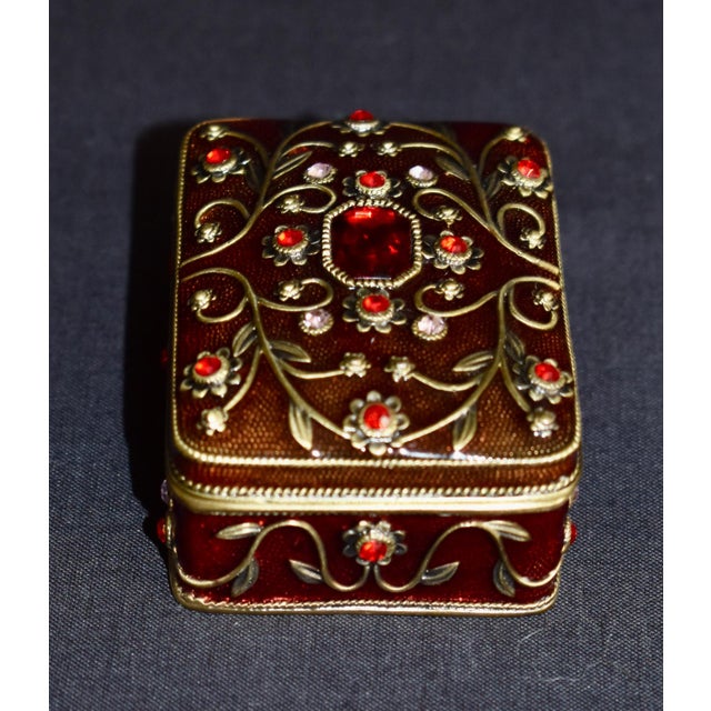 Vintage (1990's) Trinket Box is Jeweled and made of Metal. Heavy. Victorian Style. The Measurements: 2.5"W x 2"D x 1.5"H....