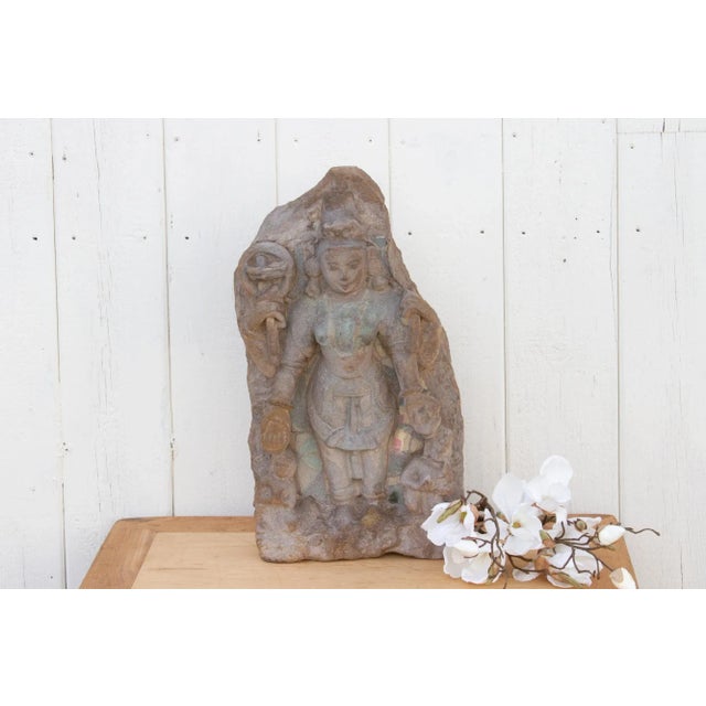 An antique finely carved statue from southern India that was originally part of an exterior wall of a temple. This antique...