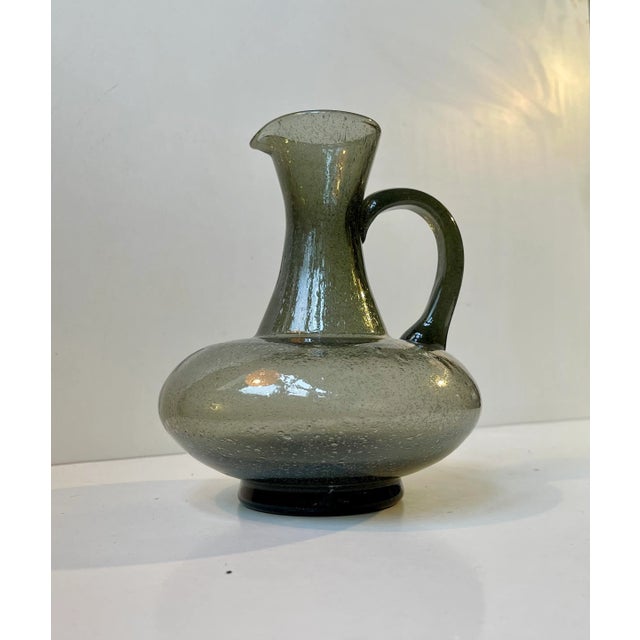 A very well-balanced glass pitcher in a smoke grey hues/nuance. Applied blister technique similar to Archimede Seguso....