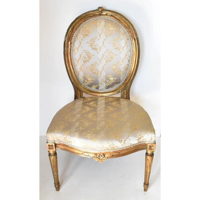 A pair of antique, late 18th-century, c. 1780 French side chairs, with oval balloon backs, carved floral designs at top...