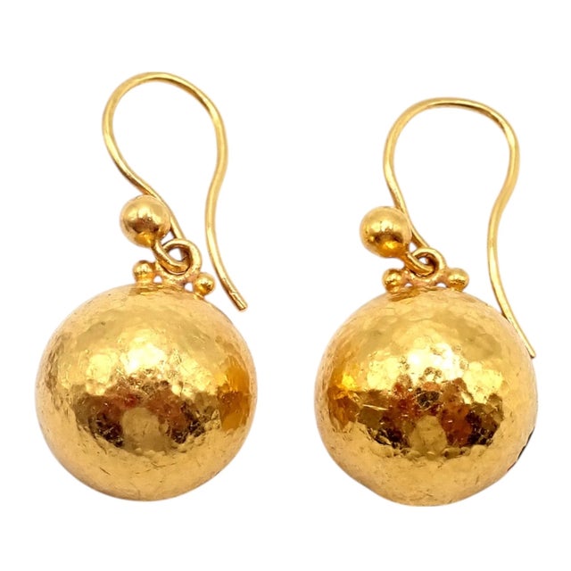 These Gurhan earrings are handcrafted in rich 24k yellow gold, featuring signature hammered ball drops that exude...