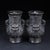 This is a striking pair of matching decorative vases, expertly carved to resemble dark horn or hardwood. The vases feature...