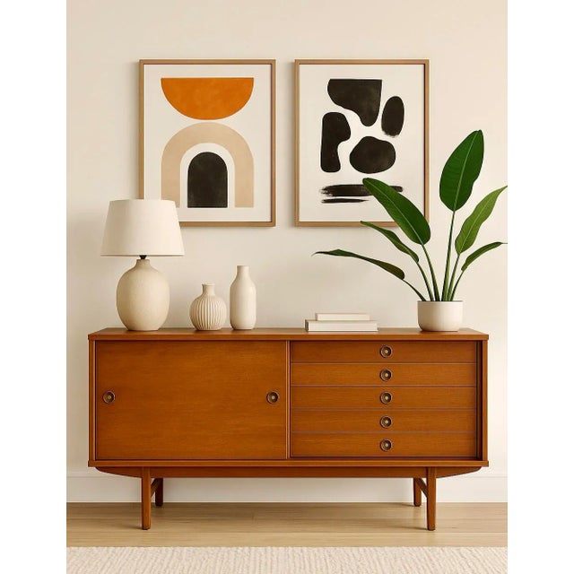Apartment sized Walnut Mid Century Modern Credenza, c. 1960s. This small yet spacious piece boasts loads of storage space...