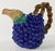 Whimsical brightly colored Fitz and Floyd ceramic 1.5 quart pitcher. Deep violet grape pattern with leaf spout and twisted...