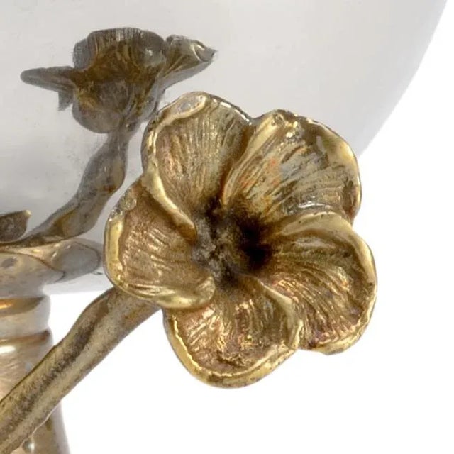 Beautiful hammered stainless steel bowl with an antique brass pedestal and sculpted orchid. The exquisite details make...