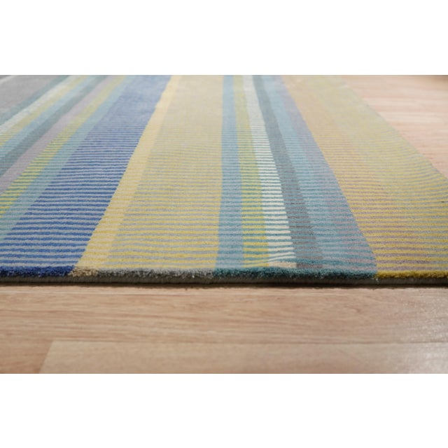 Serene Xena Green Handmade Wool Rug, Country of Origin: India. This exceptional piece introduces a sophisticated, striated...