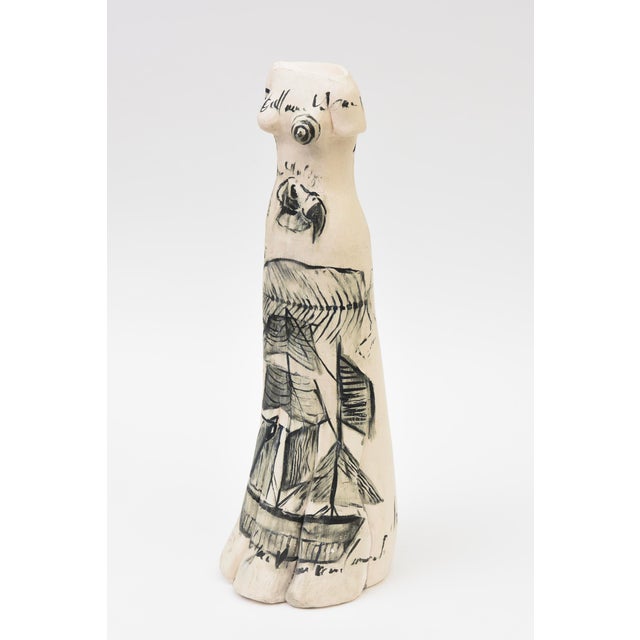 This very arresting and conversational tall ceramic sculpture is of female figure adorned wth abstract designs has great...
