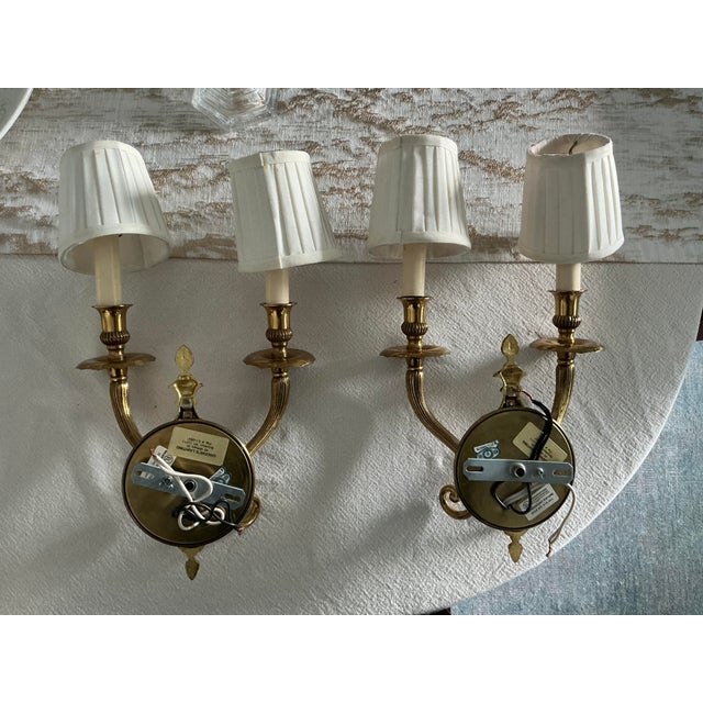 Elevate your space with this exceptional matching pair of custom-made mid-century solid cast brass wall sconces, bespoke-...