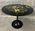 Large vintage original round "fiori della notte" table with transfer-printed wooden top and fluted black base, can be used...
