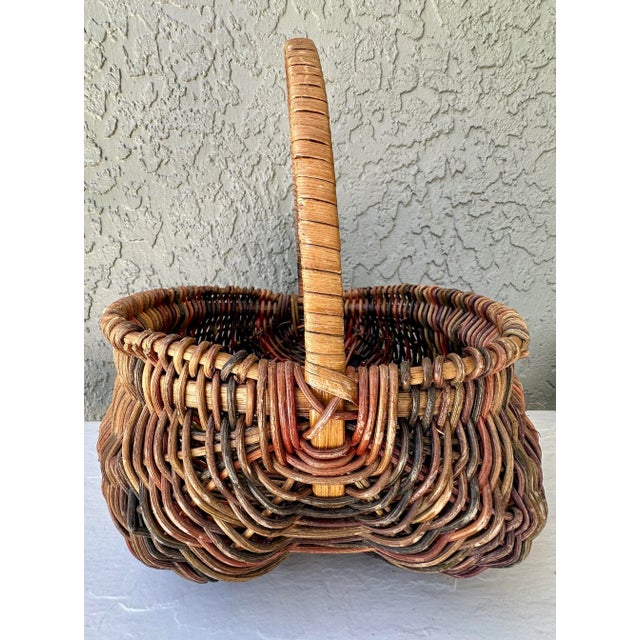 Nice vintage buttocks style basket. Natural and multicolored. Measures 10” long x 10” wide x 12” tall. Basket is 5” deep.
