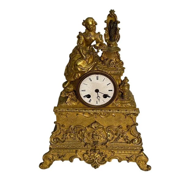 Bronze table clock, France, 19th century Elegant bronze clock depicting a devout noblewoman. The mechanism requires...