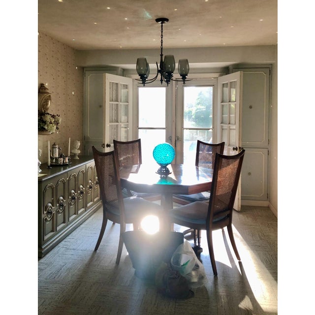 Crafted by Weiman, this table features a striking octagonal top with a beautifully matched sunburst top, resting on a...
