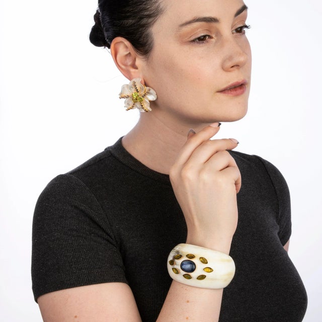 The Eliana Cuff, crafted from semi-precious stones, is an exquisite horn cuff adorned with multiple colorful stones,...