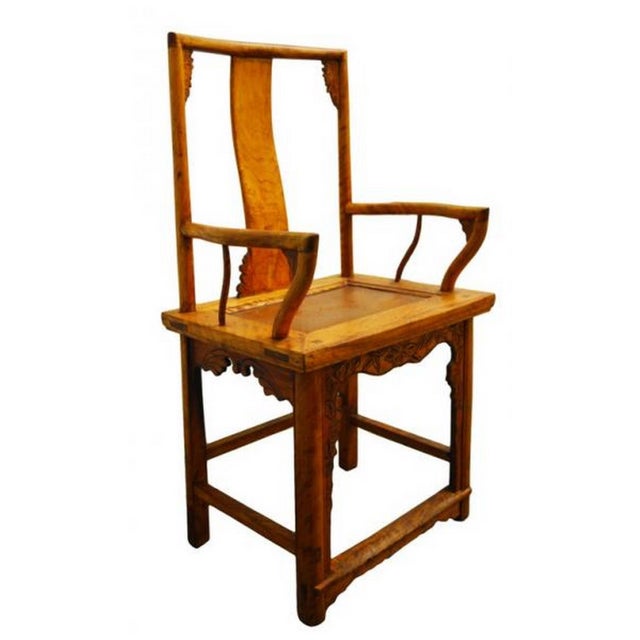 A 19th century Chinese carved chair made of lacquered elmwood. This chair displays a classic Chinese shape with its...