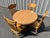 This charming oak dining set by Virginia House, featuring a paw foot table and four press back chairs, exudes a warm,...
