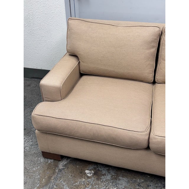 Design Plus Gallery presents a Woven Tan Tweed Village Square Apartment Sofa. The sofa has fine lines and clean silhouette...