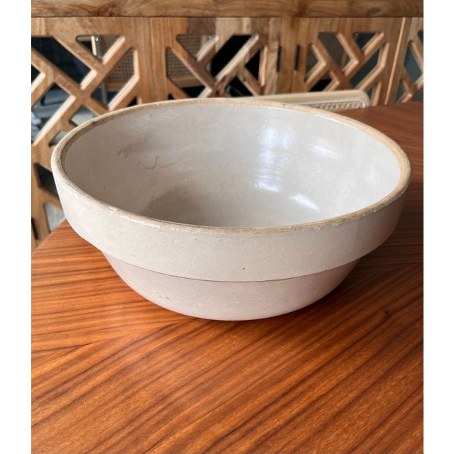 A 1930s vintage stoneware bowl in a beautiful neutral beige glaze with a raw edge. The perfect size and color.