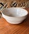 A 1930s vintage stoneware bowl in a beautiful neutral beige glaze with a raw edge. The perfect size and color.