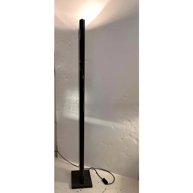 The elegant bright black up-lighter is made of sheet metal and rests on cast iron base. It projects a strong light on the...