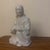 An elegant mid-20th-century vintage glazed white porcelain okimono (decorative figurine) depicting a seated or kneeling...
