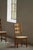 A beautiful set of six high-back dining chairs designed by Henning Kjærnulf and crafted in Denmark during the 1960s–1970s....